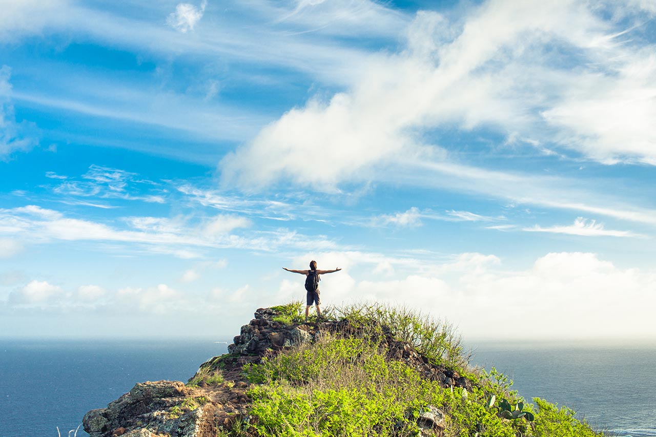 woman standing happily on ledge