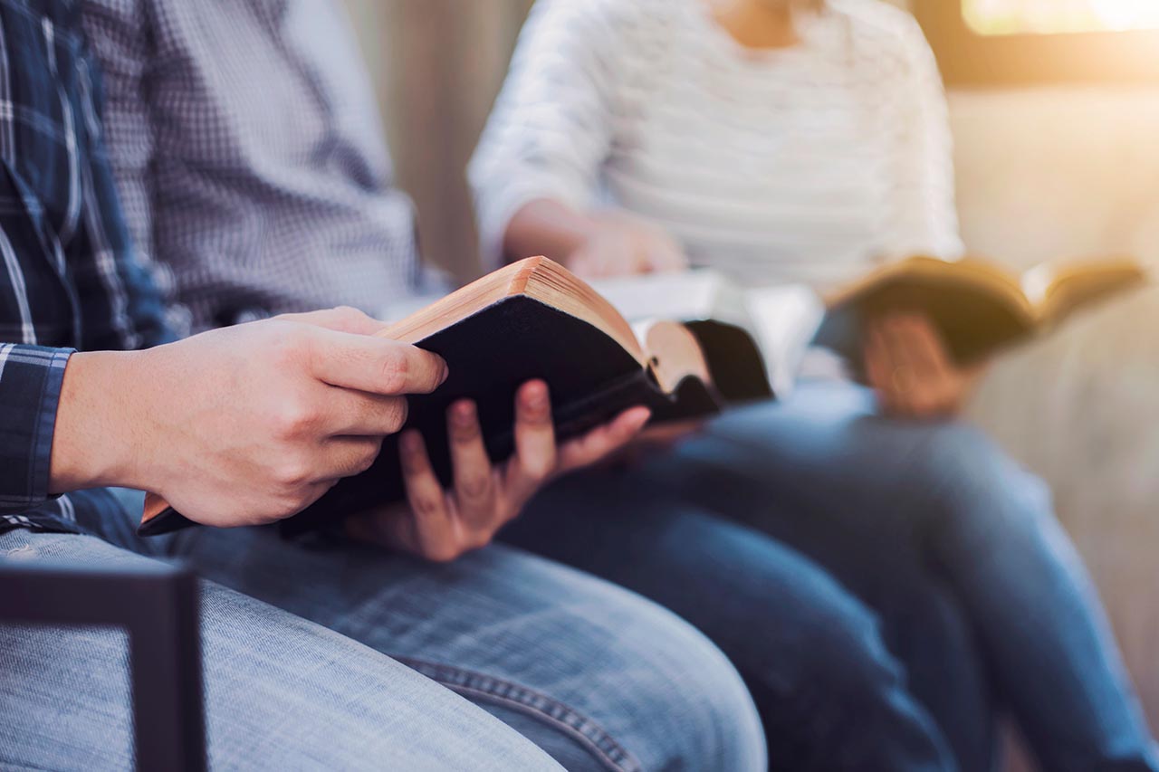 woman and man holding bibles