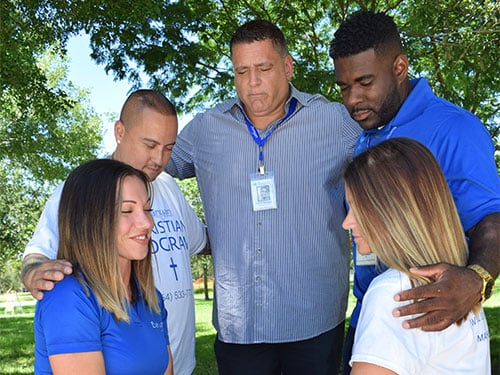 a group of people praying