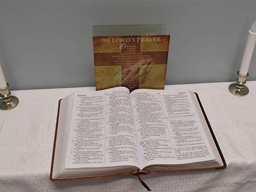 an open bible laying on a table